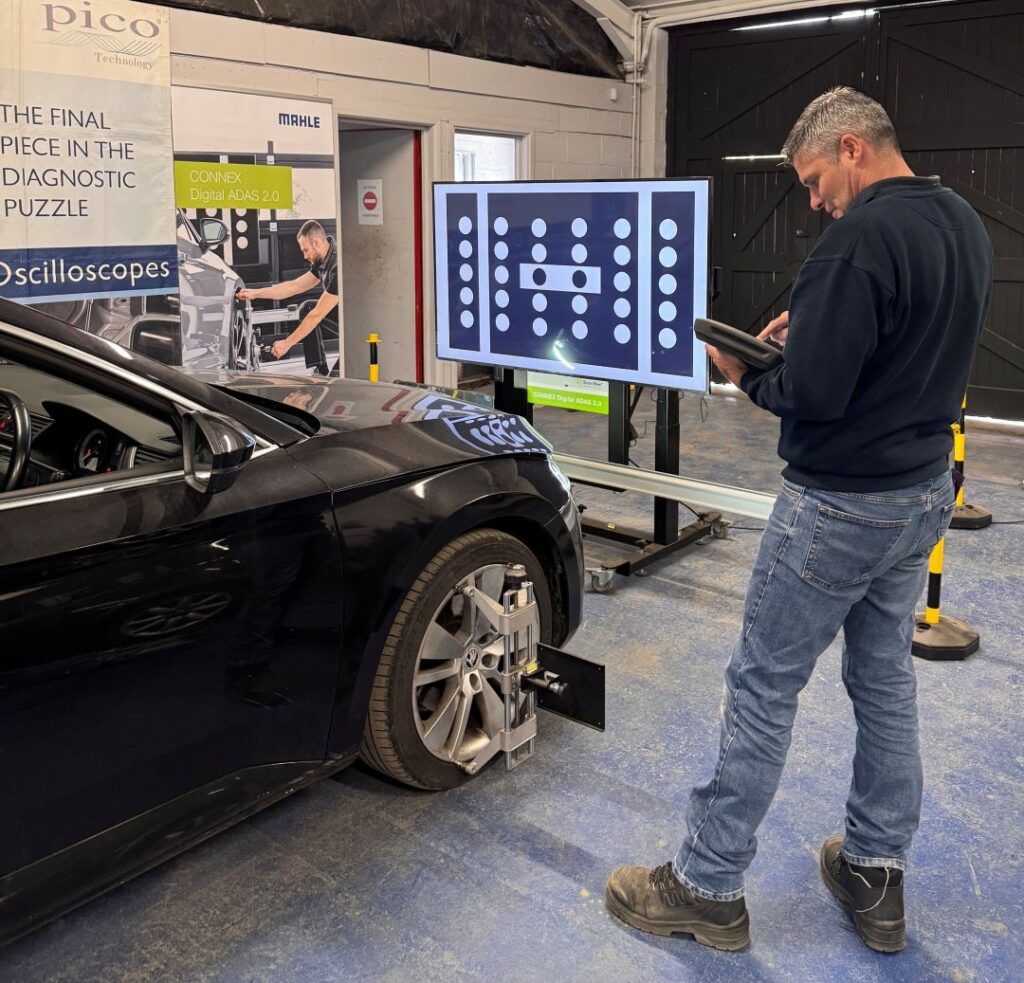Technician carrying out ADAS calibration training using MAHLE Digital ADAS equipment at RMT's IMI Approved Training Centre in Oswestry.