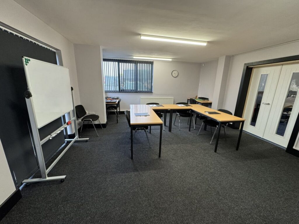 Small-group automotive training classroom at RMT's IMI Approved Training Centre in Oswestry, providing hands-on technical training and individual support.