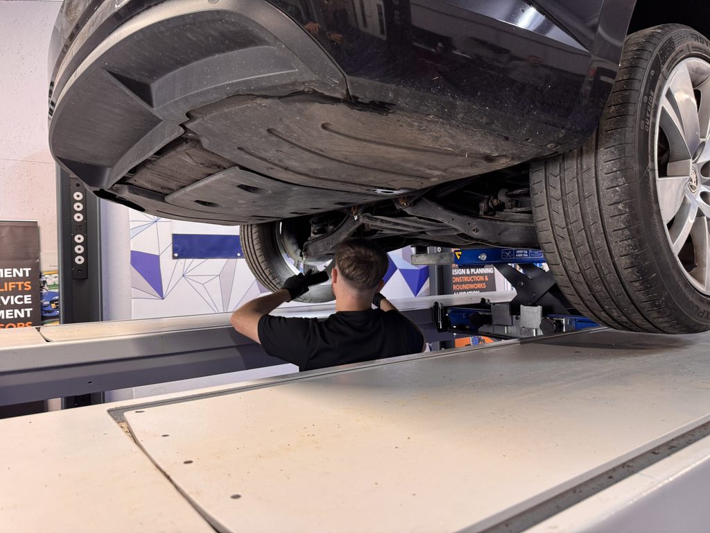 MOT Tester candidate carrying out an underside vehicle inspection during practical training